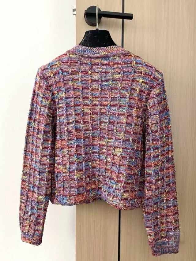 Patterned buttons and logo embellishments on cardigan