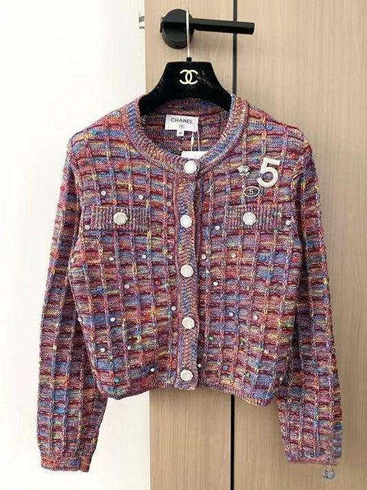 Patterned buttons and logo embellishments on cardigan