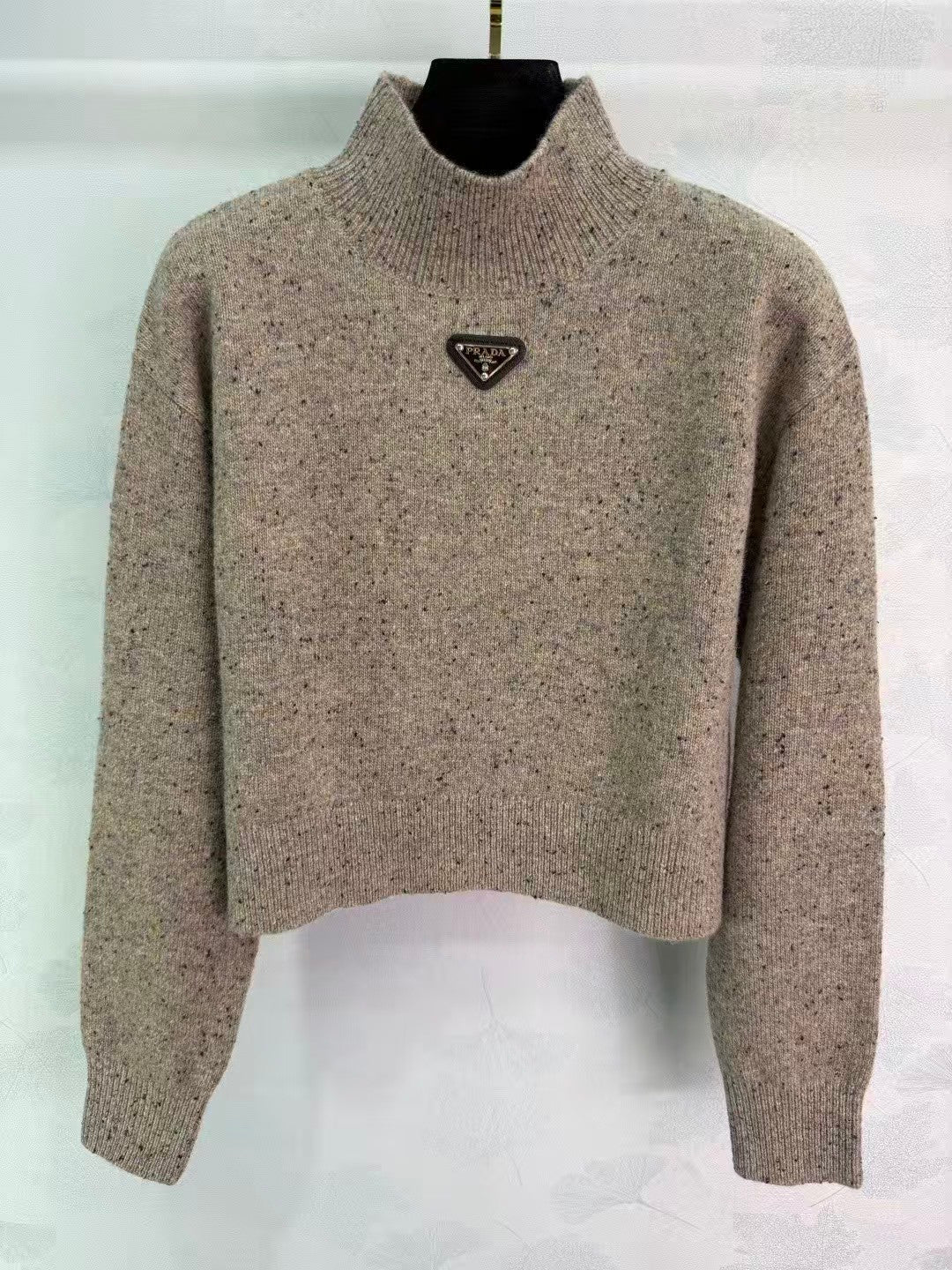 Stand-up collar triangular logo sweater