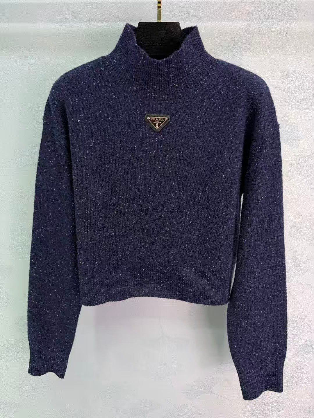 Stand-up collar triangular logo sweater
