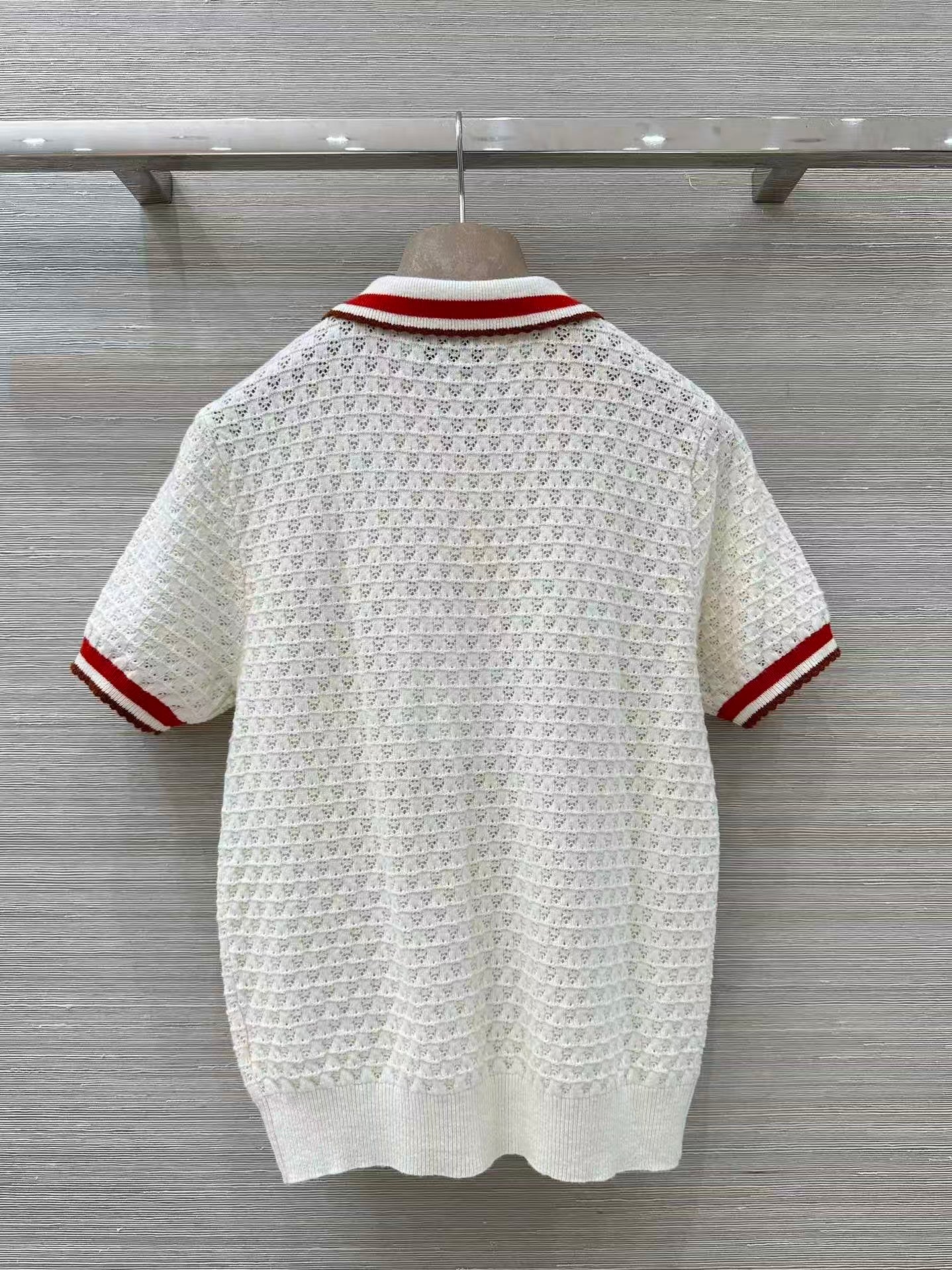 Retro-style polo shirt with cut-out details.